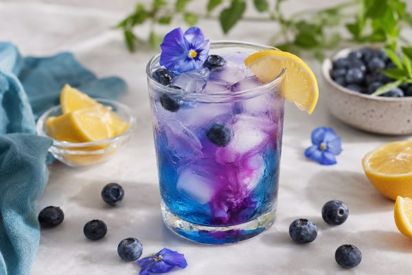 Blue Flower Lemon Magic Iced Tea changing from blue to violet with lemon