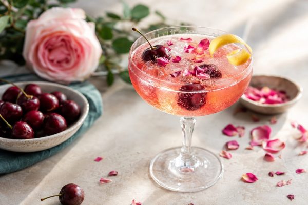 Cherry Rose Blossom Spritz tea mocktail with cherries and rose petals